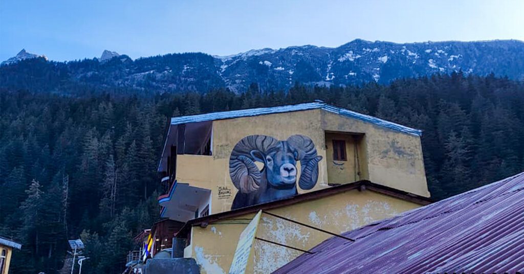 Traditional house with mountain goat mural in Harsil Valley 