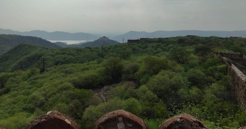 View of Garh Ganesh Temple from Charan Mandir overlooking the lush Aravalli hills