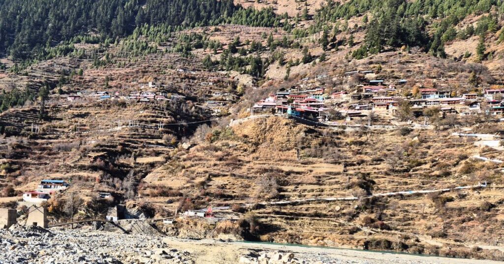 Panoramic view of Mukhba village with traditional houses spread across Himalayan slopes